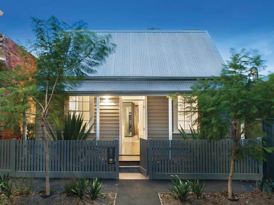 Small tin roof house with picket frence